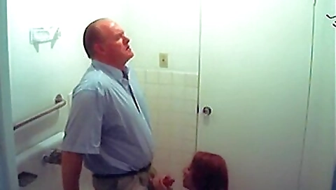 A redhead babe with a big booty is fucking herself in the bathroom