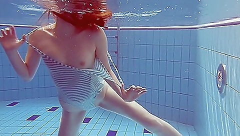 Sexy brunette in a striped body suit shows off her body